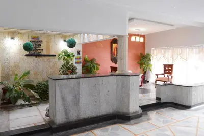 a lobby with a reception desk and potted plants at CASA ZOE in Cartagena de Indias