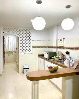 a kitchen with a table with a bowl of fruit on it at Casa Dimares in Cartagena de Indias