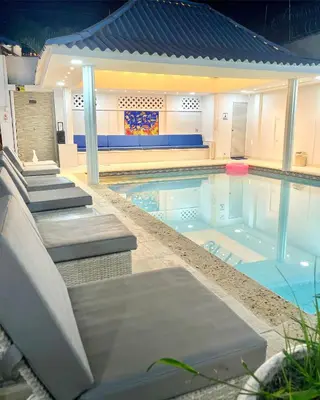 a swimming pool with chairs at Casa Dimares in Cartagena de Indias