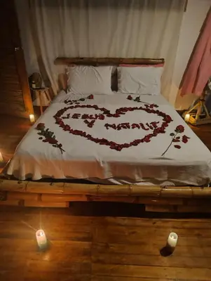 a bed with a heart made out of flowers on it at Laguna Rosa Glamping in Coveñas