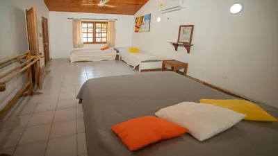 a bedroom with two beds and a couch at Cabana Canaima in Coveñas