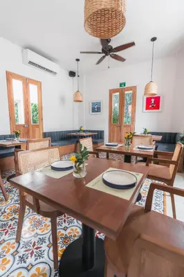 a dining room with wooden tables and chairs at Casa Jaguar Hotel Boutique in Cartagena de Indias