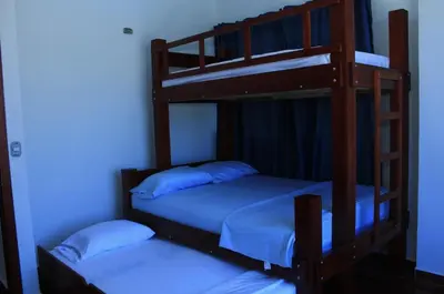 two bunk beds in a room with blue lighting at Cabaña Villas de Santa Veronica in Juan de Acosta