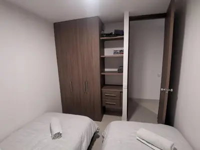 a small bedroom with two beds and a closet at Hermoso Apartamento Zona Norte Miramar # in Barranquilla