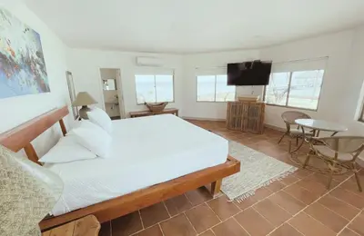 a bedroom with a bed and a flat screen tv at Quinta del Mar Crystal Beach in Tintipan Island