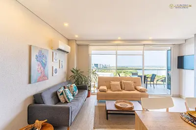 a living room with a couch and a table at Martinique Cartagena - Apartamentos A Corta Caminata De Playa Azul in Cartagena de Indias
