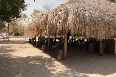 a straw hut with a hammock under it at Club Camping Islamar in Baru