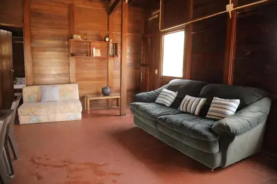 a living room with a leather couch and a chair at Club Camping Islamar in Baru