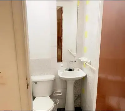 a bathroom with a toilet and a sink and a mirror at Loft in front of the sea MR1-1G neighbourhood strato alto in Cartagena de Indias