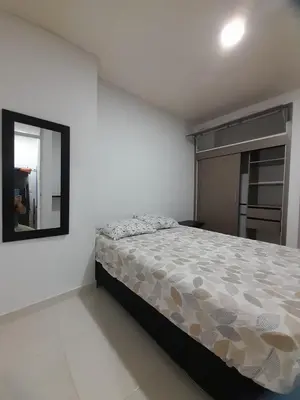 a bedroom with a bed and a mirror at Apartaestudio Cartagena in Cartagena de Indias