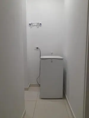 a white bathroom with a toilet in a white wall at Apartaestudio Cartagena in Cartagena de Indias
