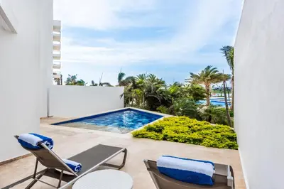 a view from the balcony of a villa with a swimming pool at Dreams Karibana Cartagena Golf & Spa Resort in Cartagena de Indias