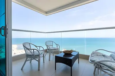 a room with chairs and a table and a view of the ocean at Laurdhomes Palmetto Beach Sew View, Hot Water in Cartagena de Indias