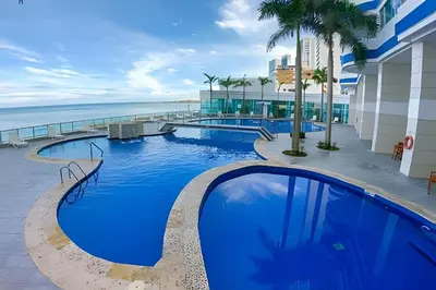 a pool at the beach hotel with the ocean in the background at LaurdHomes Palmetto Sea View, 2Rooms 2BTH Hot Ware in Cartagena de Indias