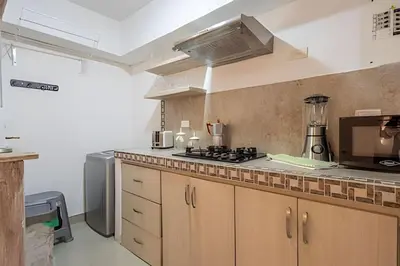 a kitchen with a stove and a counter top at Laurdhomes Duplex Old City, Plaza Santo Domingo in Cartagena de Indias