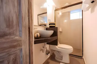a bathroom with a toilet and a sink at Laurdhomes Duplex Old City, Plaza Santo Domingo in Cartagena de Indias