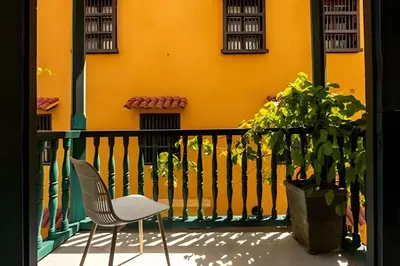 a chair and a plant on a balcony at Laurdhomes Historic Center Plaza SantoDomingo 3Bth in Cartagena de Indias