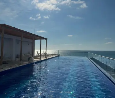 a swimming pool with a view of the ocean at Sunny House in Cartagena de Indias
