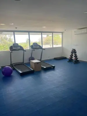 a gym with two chairs and a box in a room at Sunny House in Cartagena de Indias