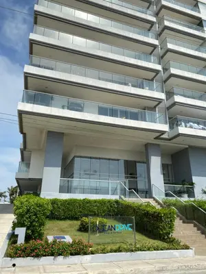 an apartment building with a sign in front of it at Sunny House in Cartagena de Indias