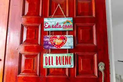 a red door with signs on it at ORESCA Hostel in Cartagena de Indias