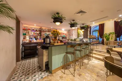 a bar in a restaurant with bar stools at Hotel Voilá Centro Histórico in Cartagena de Indias