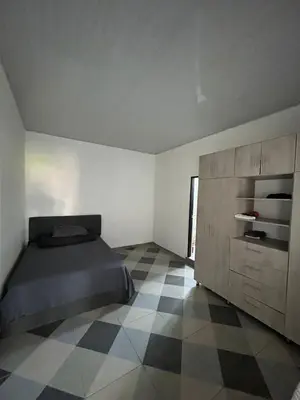 a bedroom with a bed and a tiled floor at Amiri in Puerto Colombia