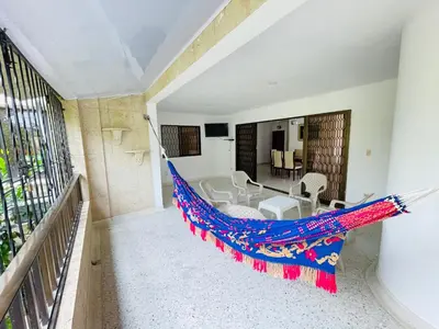 a hammock in the living room of a house at MADILI DEL MAR in Santiago