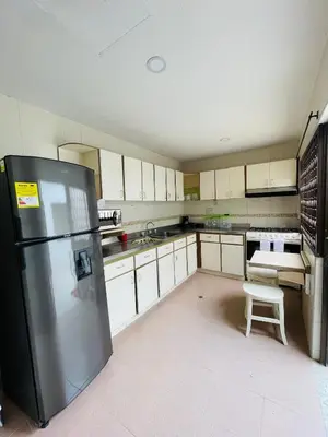 a kitchen with a refrigerator and a chair in it at MADILI DEL MAR in Santiago