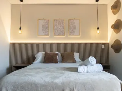 a bedroom with a white bed with two pillows at Oceanview Escape Pool, Jacuzzi & Gym in Bocagrande in Cartagena de Indias