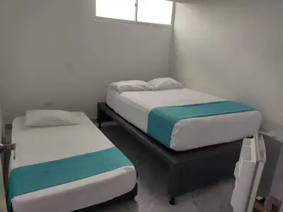a room with two beds and a window at Sky view hotel tolu in Tolú