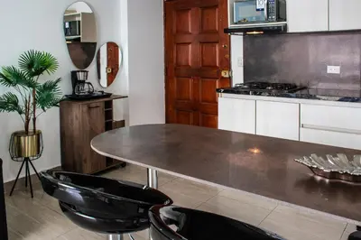 a kitchen with a table and a stove at Polanco Residences Tocagua Cartagena - Colombia in Cartagena de Indias