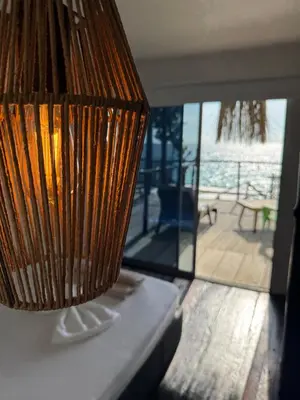 a lamp on a table with a view of a deck at SUNSET BEACH in Playa Blanca