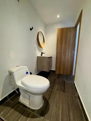 a bathroom with a white toilet and a mirror at SUNSET BEACH in Playa Blanca