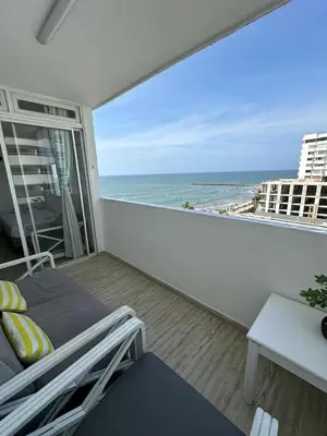 a balcony with a bed and a view of the ocean at Vista al Mar Fragata Style in Cartagena de Indias