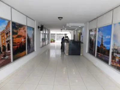 a hallway with paintings on the walls of a building at Apartaestudio amoblado en Bocagrande - Cartagena de Indias in Cartagena de Indias