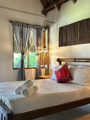 a bedroom with a bed with towels on it at Kite Eco House Salinas del rey in Salina de Rey
