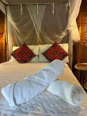 a bed with a white towel on top of it at Kite Eco House Salinas del rey in Salina de Rey