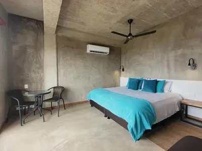 a bedroom with a bed and a table and chairs at BREES in Santa Veronica