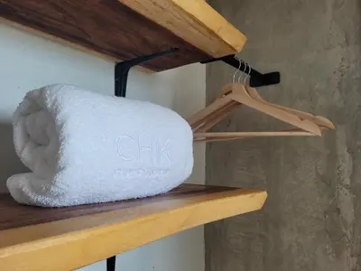 a white towel on a wooden shelf at BREES in Santa Veronica