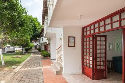 an entrance to a house with a red door at Hermosa Cabana con Piscina 3 Habitaciones MC21 in Coveñitas