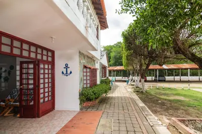 an entrance to a building with a red door at Hermosa Cabana con Piscina 3 Habitaciones MC21 in Coveñitas