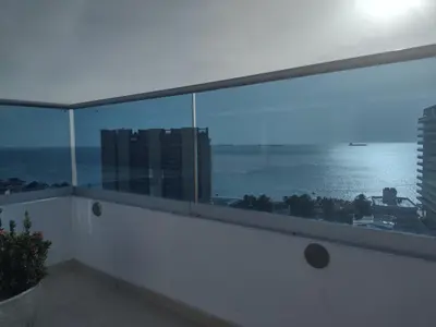 a view of the ocean from the balcony of a building at APARTAMENTO BELLO HORIZONTE in Santa Marta