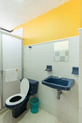 a bathroom with a toilet and a sink at Hotel Costa mar in Barranquilla