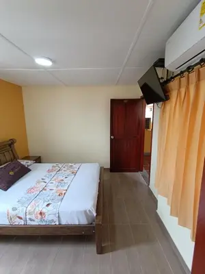 a bedroom with a bed and a tv in it at Hotel Costa mar in Barranquilla