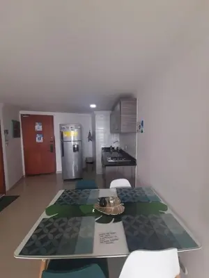 a kitchen with a table with chairs and a counter top at APARTAMENTO CON VISTA AL MAR CARIBE PISO 19 - Espectacular in Cartagena de Indias