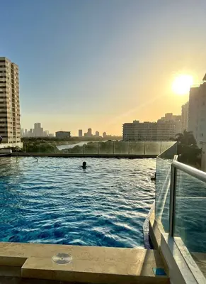 a person swimming in a swimming pool in a city at APTO DUPLEX Bella vista Piscina y buena ubicación in Cartagena de Indias