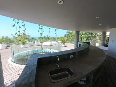 a kitchen with a sink and a view of a patio at hermoso apartamento en pozos colorados con playa privada y doble vista al mar in Santa Marta