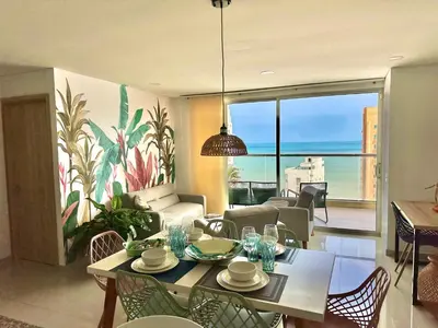 a living room with a table and chairs and a couch at New Apartments with great Sunsets near historic center and beach in Cartagena de Indias