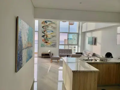 a living room with a kitchen and a living room with at New Apartments with great Sunsets near historic center and beach in Cartagena de Indias
